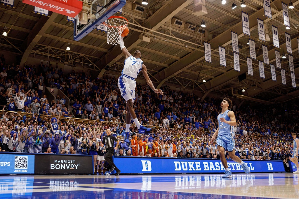 Duke's Dame Sarr (7) dunks ahead of North Carolina's Derek Dixon (3) during the second half of an NCAA college basketball game in Durham, N.C., Saturday, March 7, 2026. (AP Photo/Ben McKeown)