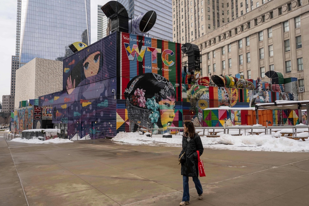 A person walks past 2 World Trade Center where American Express will build new global headquarters, Wednesday, Feb. 25, 2026, in New York. (AP Photo/Yuki Iwamura)