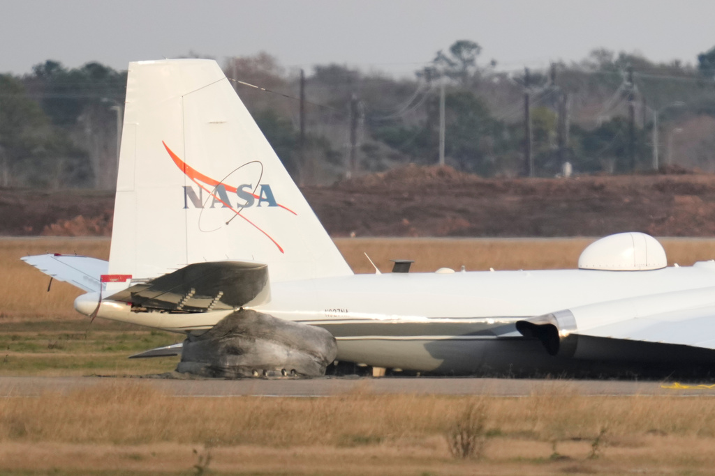 A NASA aircraft sits near a runway at Ellington Airport after making a belly landing on Tuesday, Jan. 27, 2026, in Houston. (AP Photo/Ashley Landis)