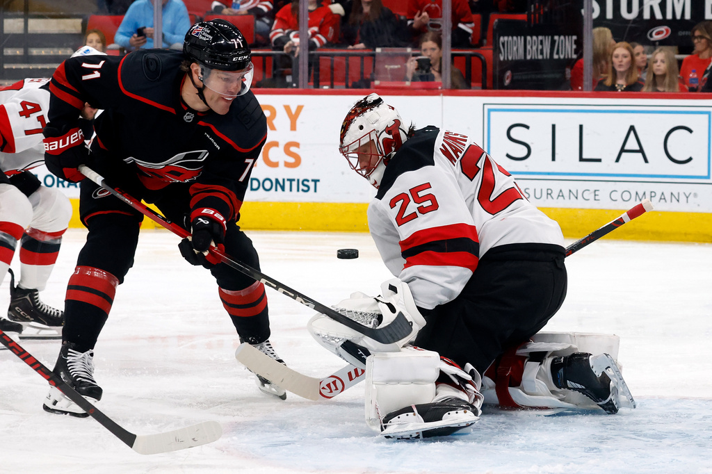Carolina Hurricanes' Taylor Hall (71) has his shot blocked by New Jersey Devils goaltender Jacob Markstrom (25) during the second period of an NHL hockey game in Raleigh, N.C., Saturday, March 28, 2026. (AP Photo/Karl DeBlaker)