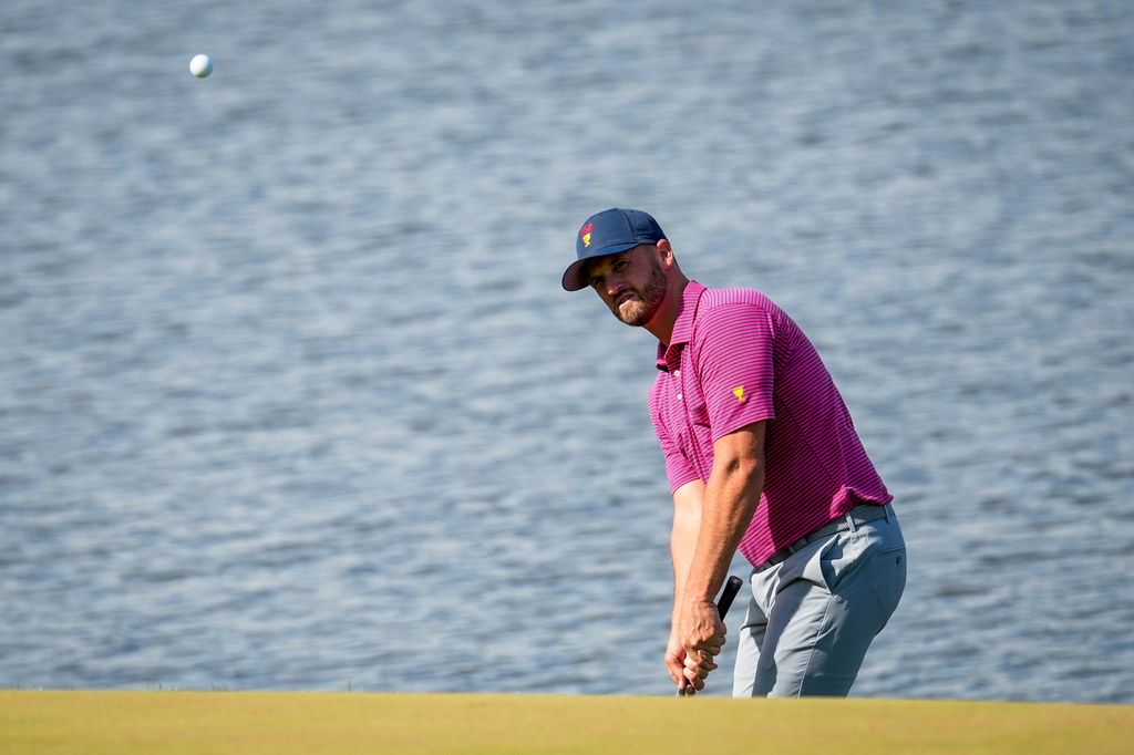 USA teams' Wyndham Clark chips onto the 16th green against the International team during a Presidents Cup golf tournament final round singles match at Medinah Country Club, Sunday, Sept. 27, 2026, in Medinah, Ill. (AP Photo/Chris Carlson)