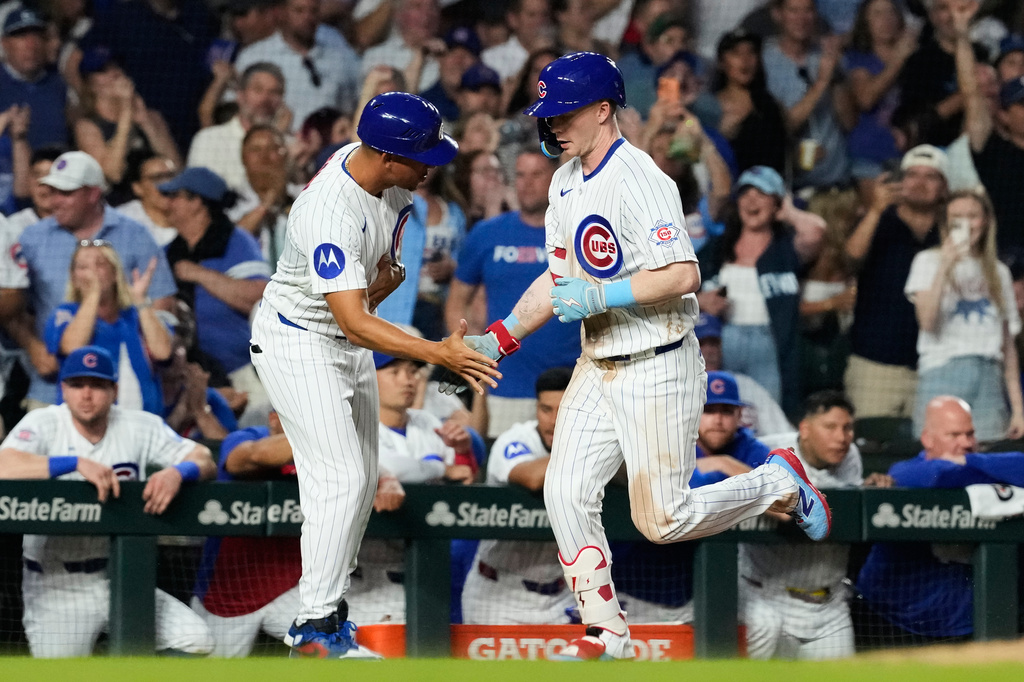 Chicago Cubs' Pete Crow-Armstrong, right, celebrates with third base coach Quintin Berry after hitting a solo home run during the sixth inning of a baseball game against the Athletics in Chicago, Thursday, June 4, 2026. (AP Photo/Nam Y. Huh)