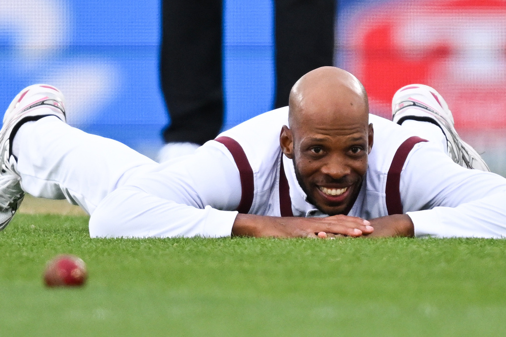 West Indies' Roston Chase lays on the ground after attempting to field against New Zealand during their cricket test match in Christchurch, New Zealand, Tuesday, Dec. 2, 2025. (Andrew Cornaga/Photosport via AP)