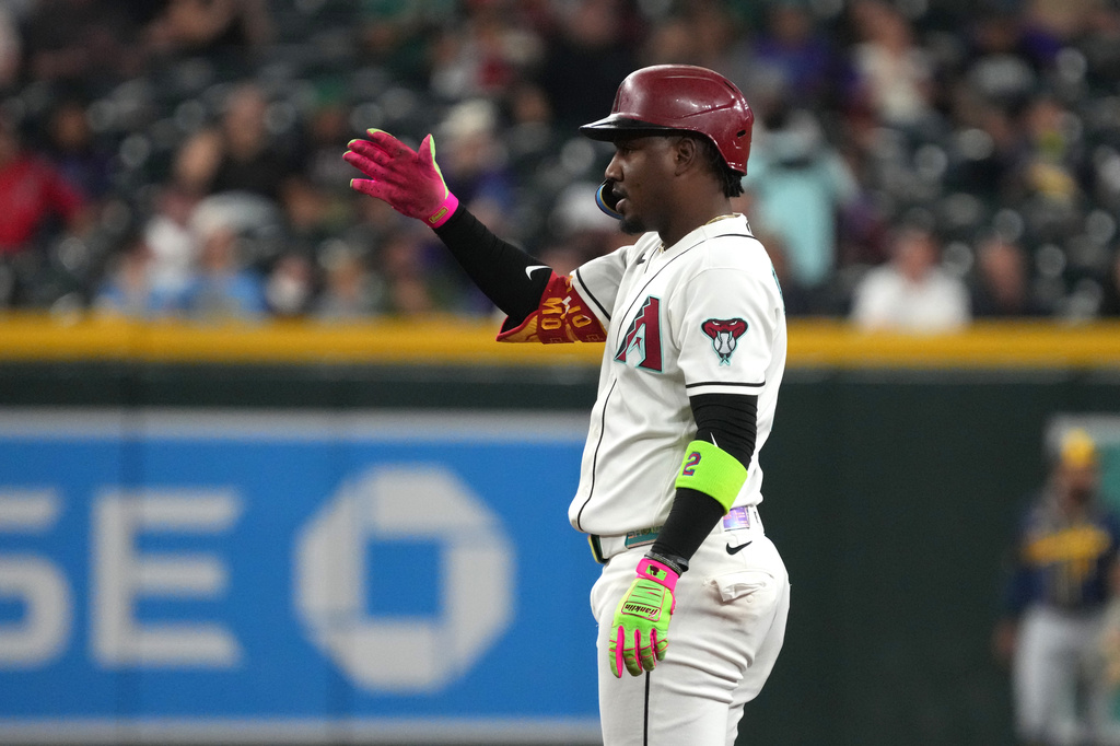 Arizona Diamondbacks' Geraldo Perdomo reacts after hitting a double against the Milwaukee Brewers in the first inning of a baseball game, Sunday, July 5, 2026, in Phoenix. (AP Photo/Rick Scuteri)