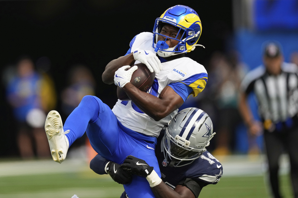 Los Angeles Rams wide receiver Xavier Smith (19) makes a catch over Dallas Cowboys safety Markquese Bell (14) during the first half of an NFL preseason football game, Saturday, Aug. 9, 2025, in Inglewood, Calif. (AP Photo/Mark J. Terrill)
