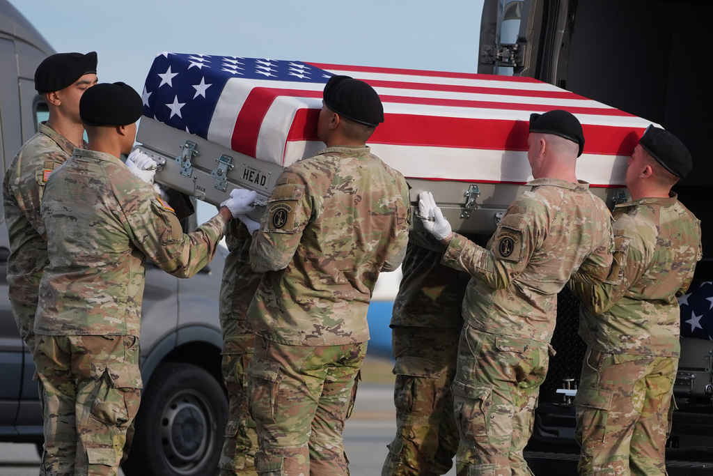 An Army carry team places the flag-draped transfer case with the remains of civilian interpreter Ayad Mansoor Sakat of Macomb, Mich., into the transfer vehicle during a casualty return, Wednesday, Dec. 17, 2025, at Dover Air Force Base, Del. (AP Photo/Evan Vucci)