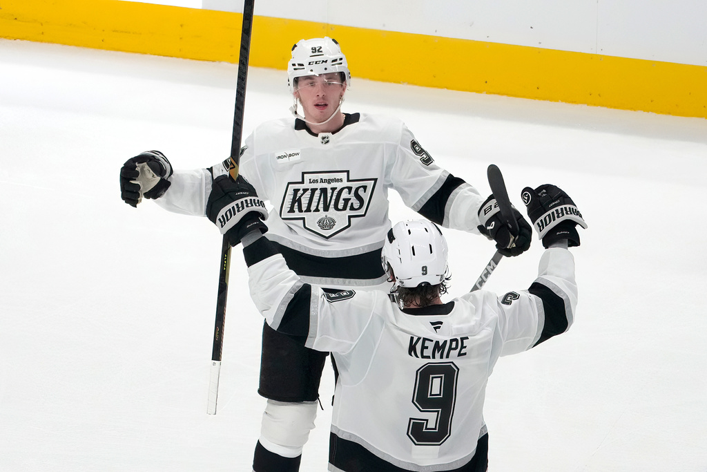 Los Angeles Kings' Brandt Clarke (92) celebrates with Adrian Kempe (9) after scoring a goal against the San Jose Sharks during the third period of an NHL hockey game in San Jose, Calif., Tuesday, Oct. 28, 2025. (AP Photo/Tony Avelar)