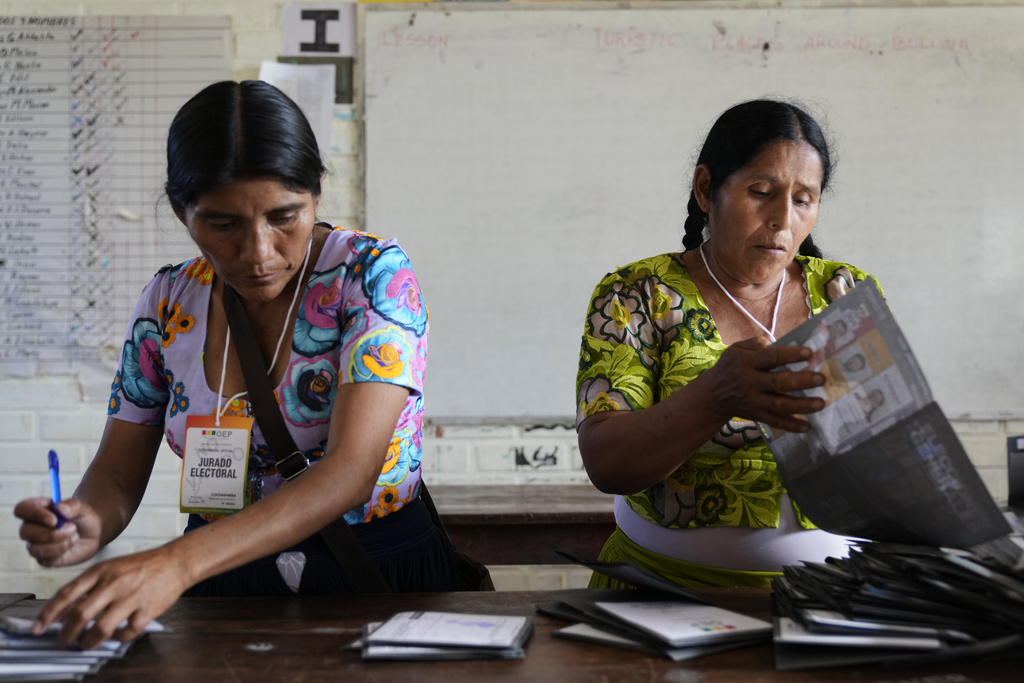 Electoral officials count votes after polls closed during general elections, in Entre Rios, Chapare region, Bolivia, Sunday, Aug. 17, 2025. (AP Photo/Jorge Saenz)