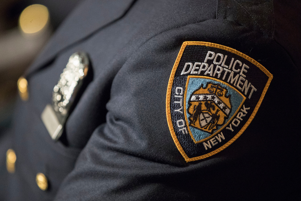 FILE- A detail including the badge and shield of one of the newest members of the New York City police is seen during his graduation ceremony, June 29, 2017, in New York. (AP Photo/Mary Altaffer, File)