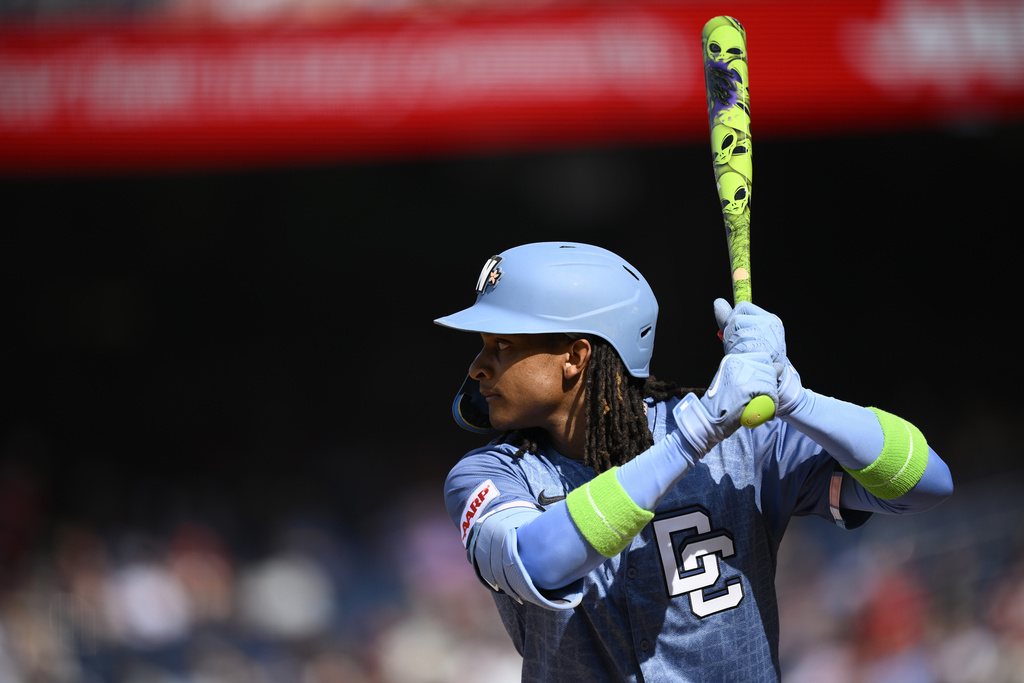 Washington Nationals' CJ Abrams uses a custom alien-themed bat during the first inning of a baseball game against the Philadelphia Phillies, Saturday, Aug. 16, 2025, in Washington. (AP Photo/Nick Wass)