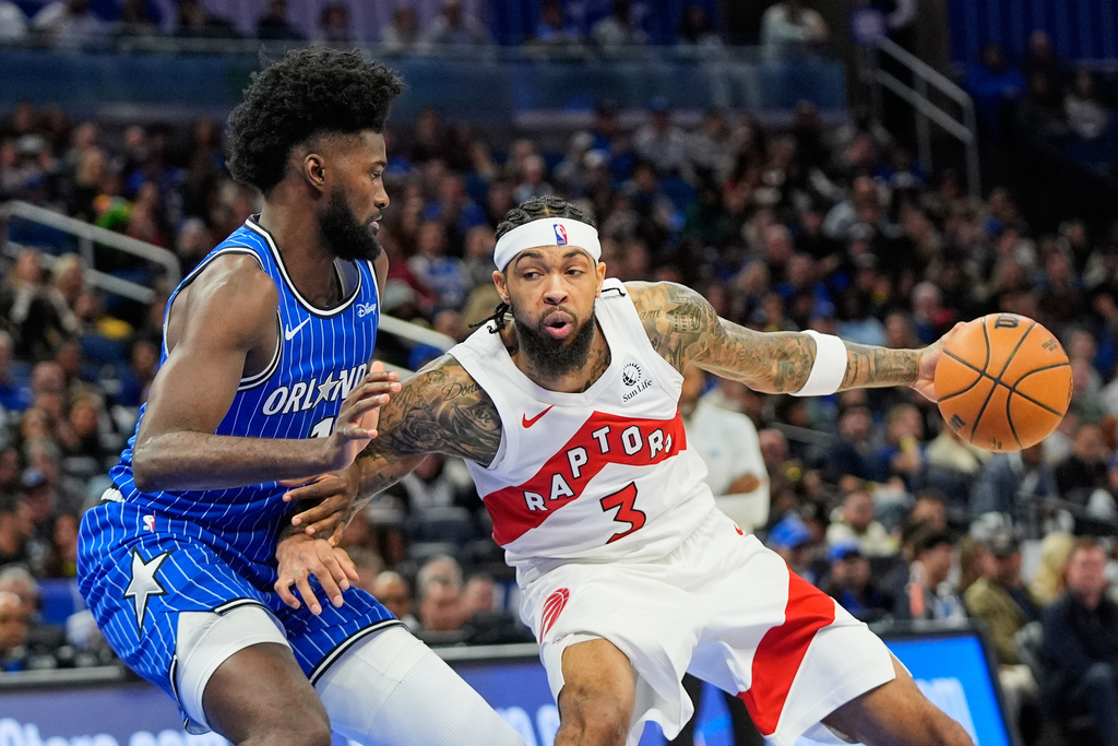 Toronto Raptors forward Brandon Ingram (3) makes a move against Orlando Magic forward Jonathan Isaac, left, during the second half of an NBA basketball game, Friday, Jan. 30, 2026, in Orlando, Fla. (AP Photo/John Raoux)