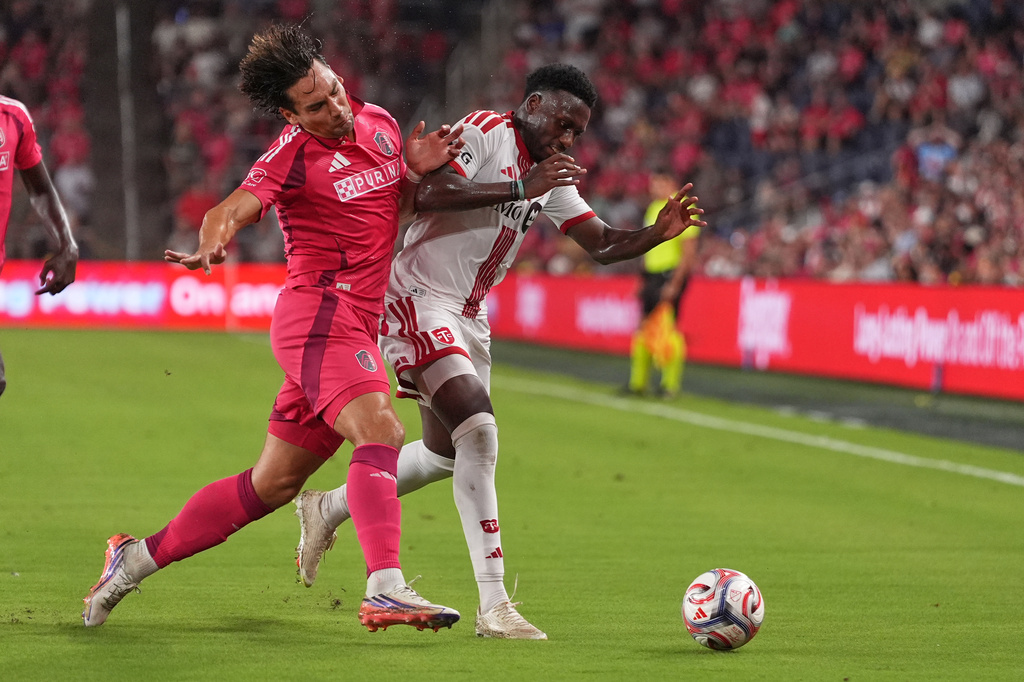 St. Louis City's Simon Becher, left, collides with Toronto FC's Derrick Etienne Jr. during the second half of an MLS soccer match Saturday, Sept. 19, 2026, in St. Louis. (AP Photo/Jeff Roberson)
