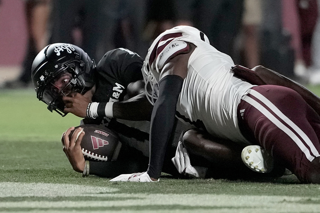 Texas A&M quarterback Marcel Reed (10) looks up from the end zone after scoring a touchdown and begin tackled by Mississippi State cornerback Kelley Jones (1) during the second half of an NCAA college football game Saturday, Oct. 4, 2025, in College Station, Texas. (AP Photo/Sam Craft)