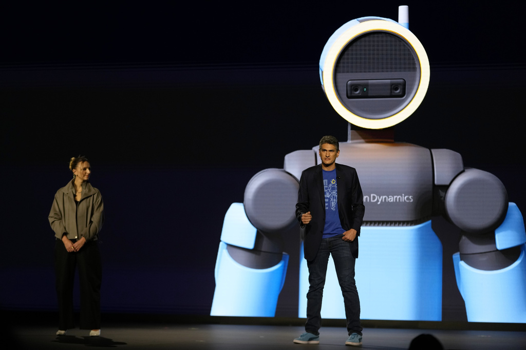 Humanoid application product lead at Boston Dynamics, Aya Durbin, left, and vice president and general manager of Atlas at Boston Dynamics, Zachary Jackowski, talk during a Hyundai and Boston Dynamics news conference ahead of the CES tech show, Monday, Jan. 5, 2026, in Las Vegas. (AP Photo/Abbie Parr)