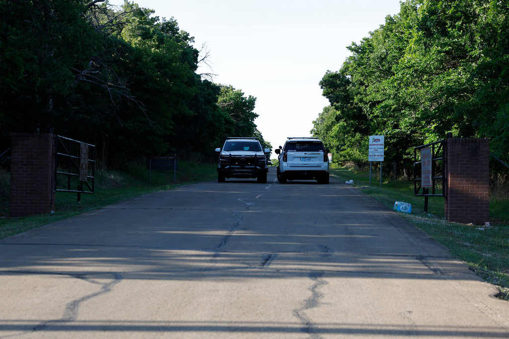 Officials block the entrance to Scissortail Campground at Arcadia Lake, Monday, May 4, 2026, in Edmond, Okla., after a shooting Sunday evening. (AP Photo/Alonzo Adams)