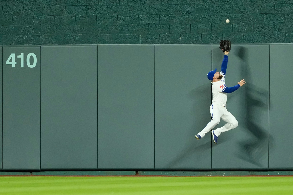 Kansas City Royals center fielder Kyle Isbel can't get to a grand slam hit by Baltimore Orioles' Leody Taveras during the 12th inning of a baseball game Monday, April 20, 2026, in Kansas City, Mo. (AP Photo/Charlie Riedel)