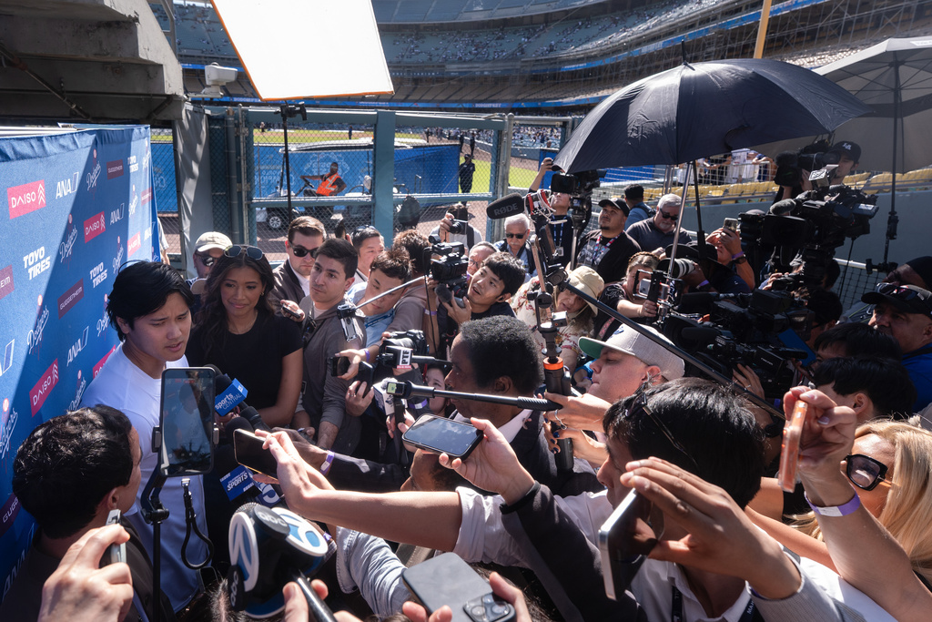 Los Angeles Dodgers' Shohei Ohtani, left, talks to reporters during DodgerFest at Dodger Stadium in Los Angeles, Saturday, Jan. 31, 2026. (AP Photo/Jae C. Hong)