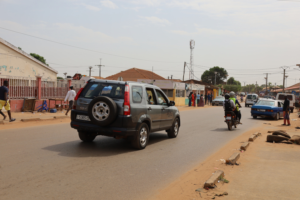Cars drive on the street in Bissau, Guinea-Bissau, Wednesday, Nov. 26, 2025. (AP Photo/Darcicio Barbosa)