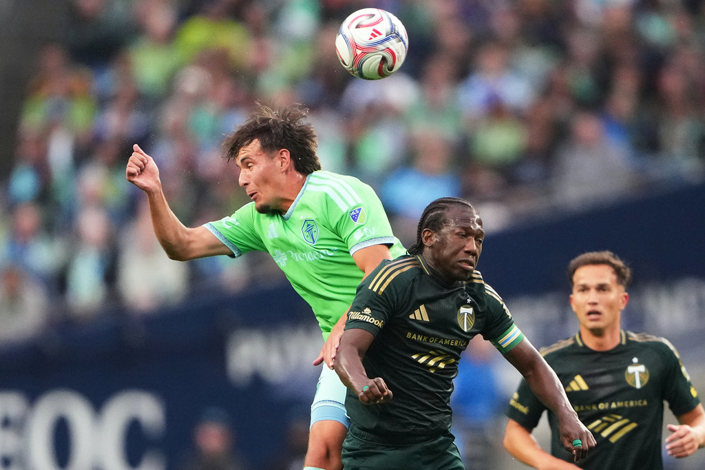 Seattle Sounders midfielder Snyder Brunell goes up for the ball against Portland Timbers midfielder Diego Chará, right, during the first half of an MLS soccer match, Thursday, July 16, 2026, in Seattle. (AP Photo/Lindsey Wasson)