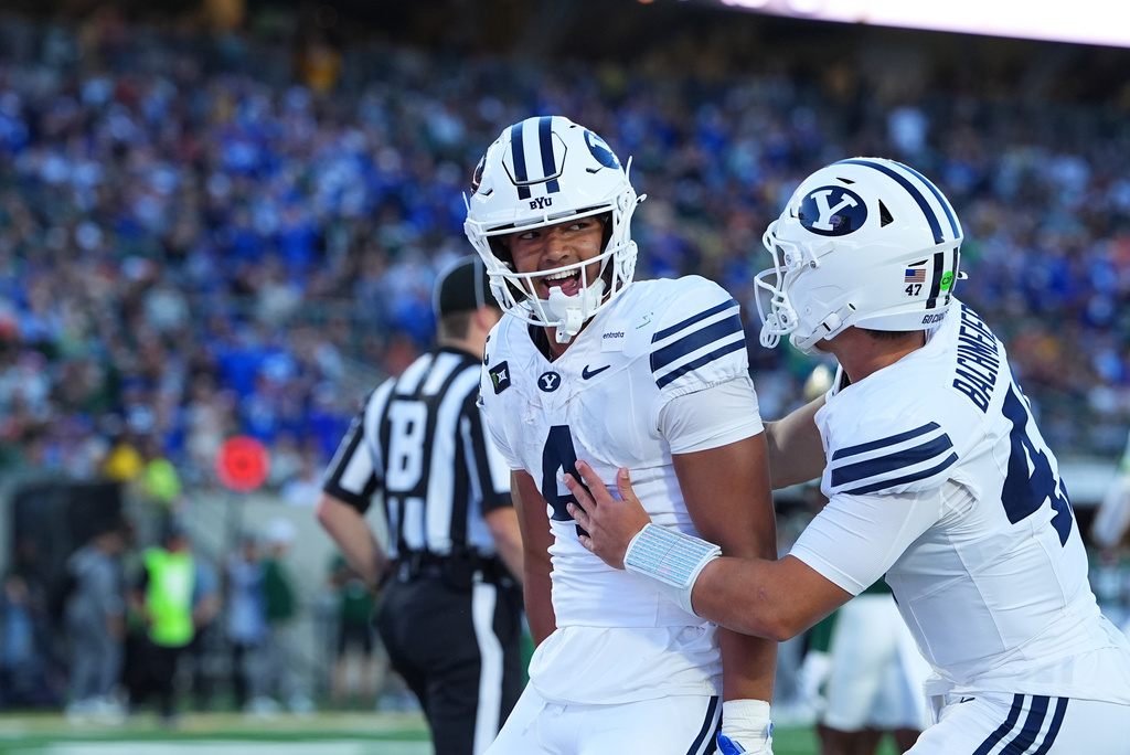 BYU running back Lj Martin, left, is congratulated after he carried the ball for a touchdown by quarterback Bear Bachmeier in the first half of an NCAA college football game against Colorado State Saturday, Sept. 19, 2026, in Fort Collins, Colo. (AP Photo/David Zalubowski)