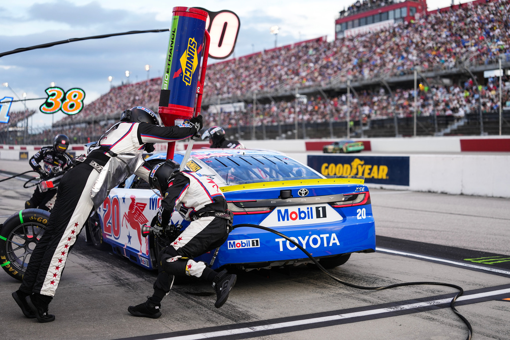 The pit crew for Christopher Bell rushes to complete a pit stop during a NASCAR Cup Series auto race at Darlington Raceway, Sunday, Sept. 6, 2026, in Darlington, S.C. (AP Photo/Matt Kelley)