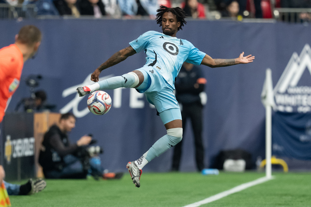 Minnesota United's Kyle Duncan jumps for the ball against the Vancouver Whitecaps during the first half of an MLS soccer match in Vancouver, British Columbia, Sunday, March 15, 2026. (Ethan Cairns/The Canadian Press via AP)