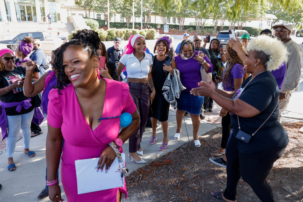 Supporters of Karmelo Anthony celebrate outside the Collin County Courthouse after Judge John Roach Jr. was recused from the next phase of Anthony's murder trial on Wednesday, Aug. 19, 2026, in McKinney, Texas. (Elías Valverde II/The Dallas Morning News via AP)