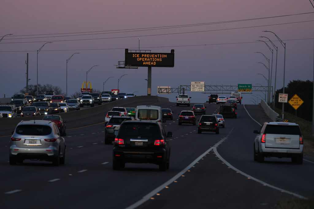A sign visible from the eastbound lanes of Highway 121 warns of road preparations ahead of inclement weather expected in the region Wednesday, Jan. 21, 2026, in Fort Worth, Texas. (AP Photo/Julio Cortez)