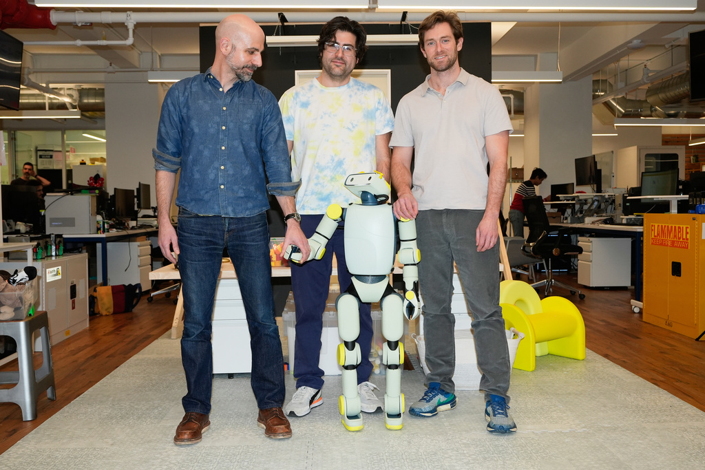Fauna Robotics VP of hardware Anthony Moshchella, left, and co-founders Josh Merel, center, and Rob Cochran, pose for a picture with Sprout, the company's new robot, at their offices in New York, Wednesday, Jan. 14, 2026. (AP Photo/Seth Wenig)