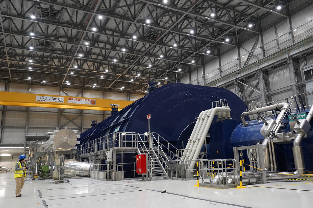 A member of the media stands in the turbine hall of Olkiluoto 3 (OL3), Europe's largest nuclear reactor, during a press tour on the island of Olkiluoto, Finland, Tuesday, Feb. 24, 2026. (AP Photo/James Brooks)