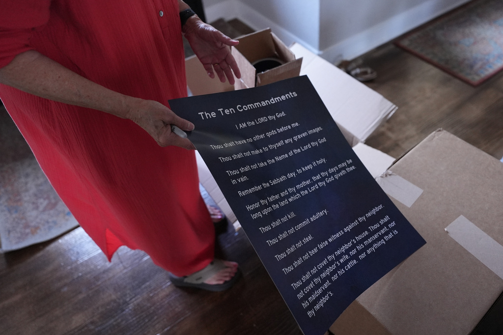 FILE - A woman prepares to deliver hundreds of Ten Commandments posters to local public schools in New Braunfels, Texas, on Nov. 17, 2025. (AP Photo/Eric Gay, File)
