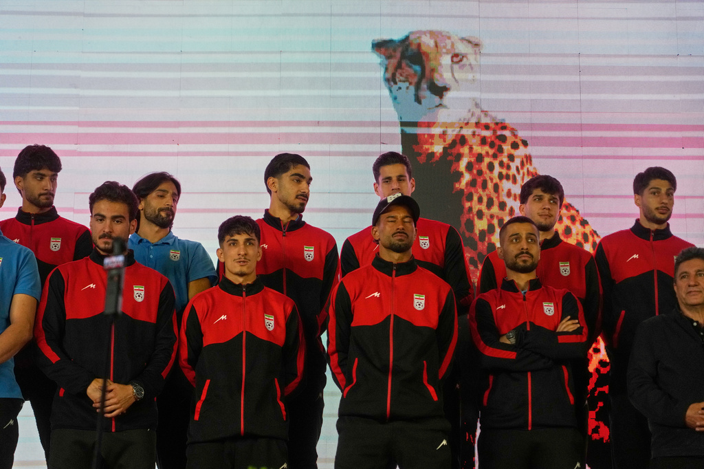 Iran's national soccer team players stand onstage as they are greeted by a crowd during a pro-government gathering before their departure for training and friendly matches in Turkey ahead of the World Cup at Islamic Revolution Square in Tehran, Iran, Wednesday, May 13, 2026. (AP Photo/Vahid Salemi)