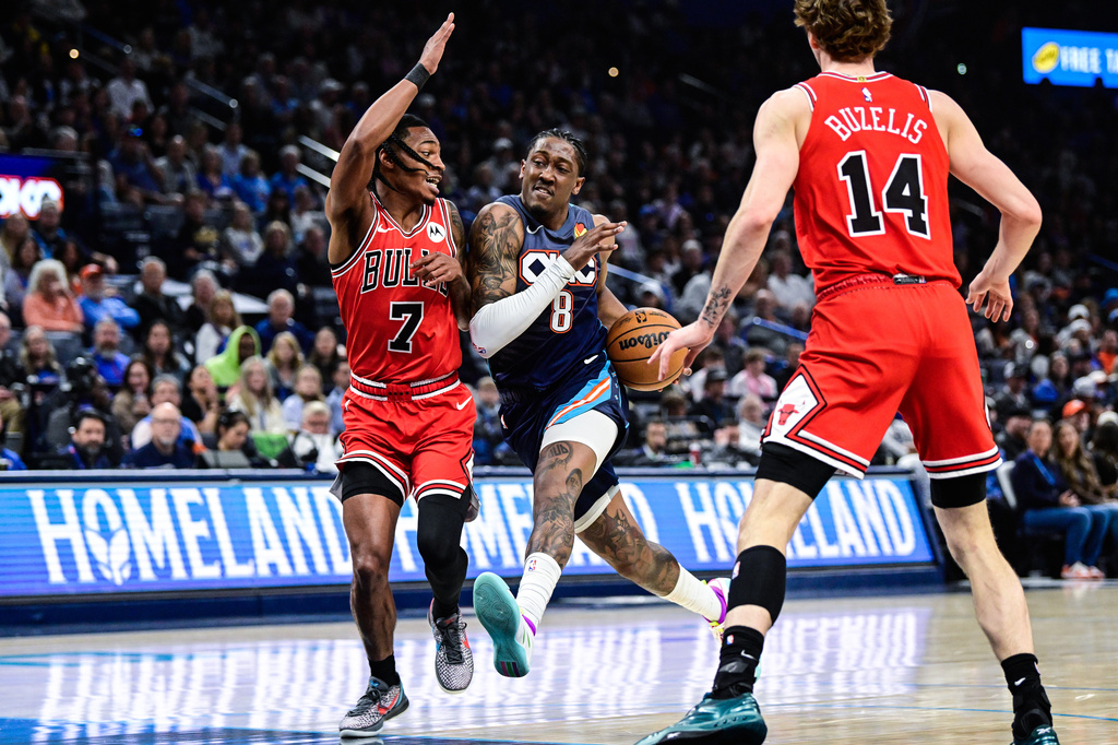 Oklahoma City Thunder guard/forward Jalen Williams (8) drives against Chicago Bulls guard Rob Dillingham (7) during the first half of an NBA basketball game Friday, March. 27, 2026, in Oklahoma City. (AP Photo/Gerald Leong)