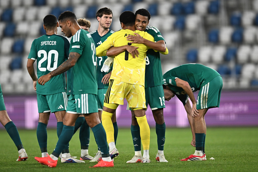 Northern Ireland's Shea Charles embraces Northern Ireland's goalkeeper Pierce Charles, back to a camera, celebrating after scoring his side's opening goal during the Nations League soccer match between Georgia and Northern Ireland in Tbilisi, Georgia, Friday, Sept. 25, 2026. (AP Photo/Tamuna Kulumbegashvili)