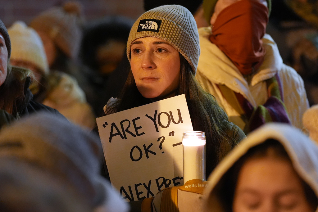 Attendees gather during a vigil where Alex Pretti was shot and killed by federal immigration enforcement in Minneapolis, on Wednesday, Jan. 28, 2026. (AP Photo/Adam Gray)