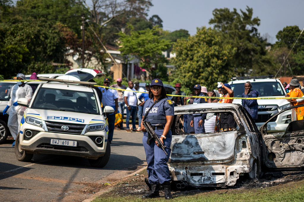 A police officer stands at the scene of a mass shooting at a house party in KwaMakhutha township south of the city of Durban, South Africa, Wednesday, Sept. 23, 2026. (AP Photo)