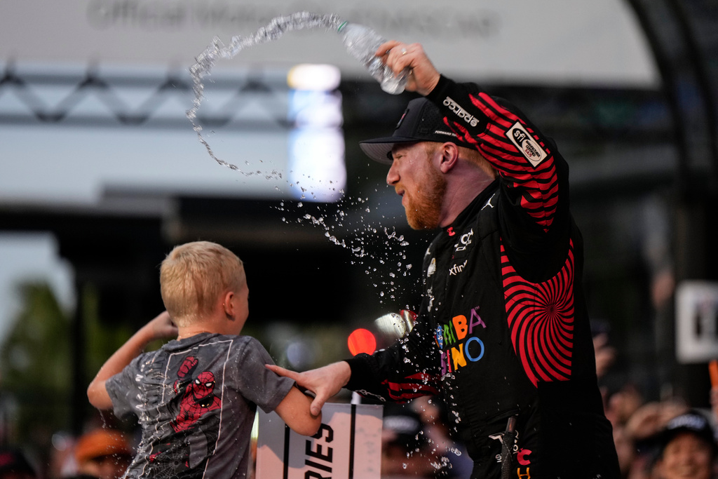 Tyler Reddick, (45) and his son Beau celebrate with the team after winning the NASCAR Daytona 500 auto race at Daytona International Speedway, Sunday, Feb. 15, 2026, in Daytona Beach, Fla. (AP Photo/Nigel Cook)