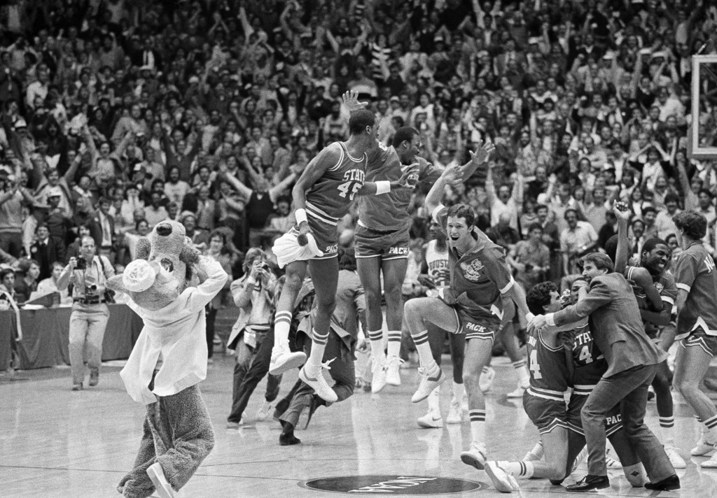 FILE - In this April 4, 1983, file photo, a high jumping Cozell McQueen (45), left center, and teammates celebrate defeating Houston 54-52 in the NCAA college basketball championship game in Albuquerque, N.M. (AP Photo/File)