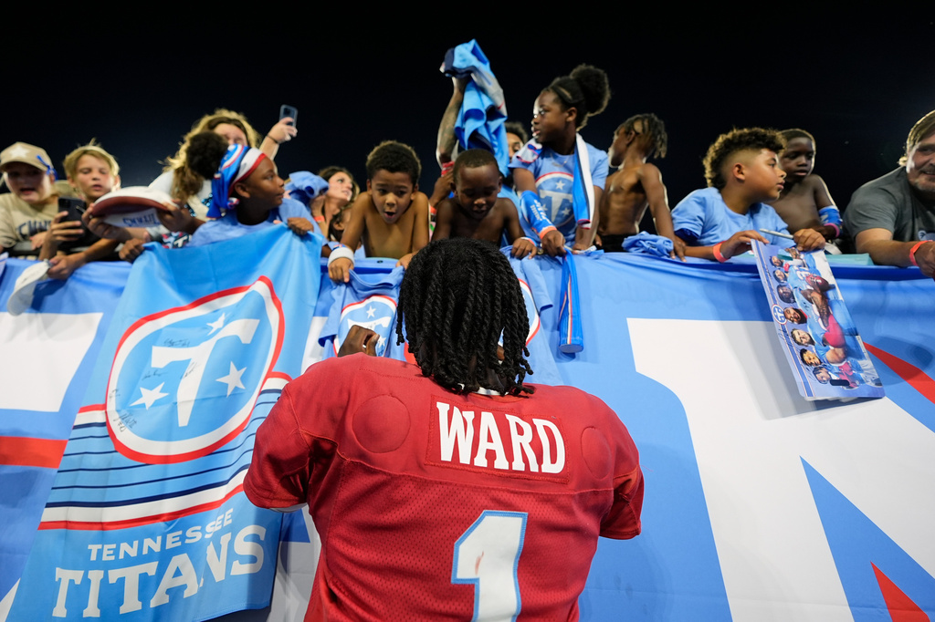 Tennessee Titans quarterback Cam Ward (1) signs autographs for fans after practice during the NFL football team's training camp Friday, Aug. 7, 2026, in Nashville, Tenn. (AP Photo/George Walker IV)