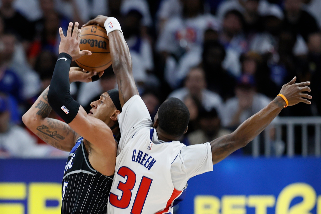 Orlando Magic forward Paolo Banchero (5) has his shot blocked by Detroit Pistons guard Javonte Green (31) during the first half in Game 2 of a first-round NBA basketball playoffs series Wednesday, April 22, 2026, in Detroit. (AP Photo/Duane Burleson)