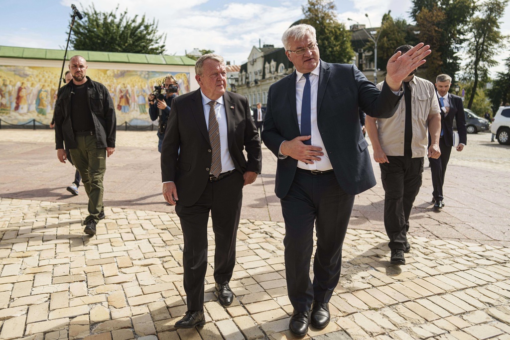 Denmark's Foreign Minister Lars Lokke Rasmussen, left, and Ukraine's Foreign Minister Andrii Sybiha, right, walk in center of Kyiv, Ukraine, on Friday, Sept. 12, 2025. (AP Photo/Evgeniy Maloletka)