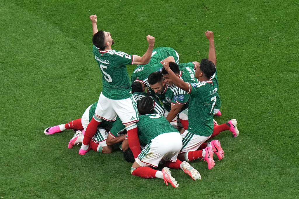 Mexico's Raul Jimenez (9) celebrates with teammates after scoring their second goal during the World Cup round of 32 soccer match between Mexico and Ecuador in Mexico City, Tuesday, June 30, 2026. (AP Photo/Silvia Izquierdo)