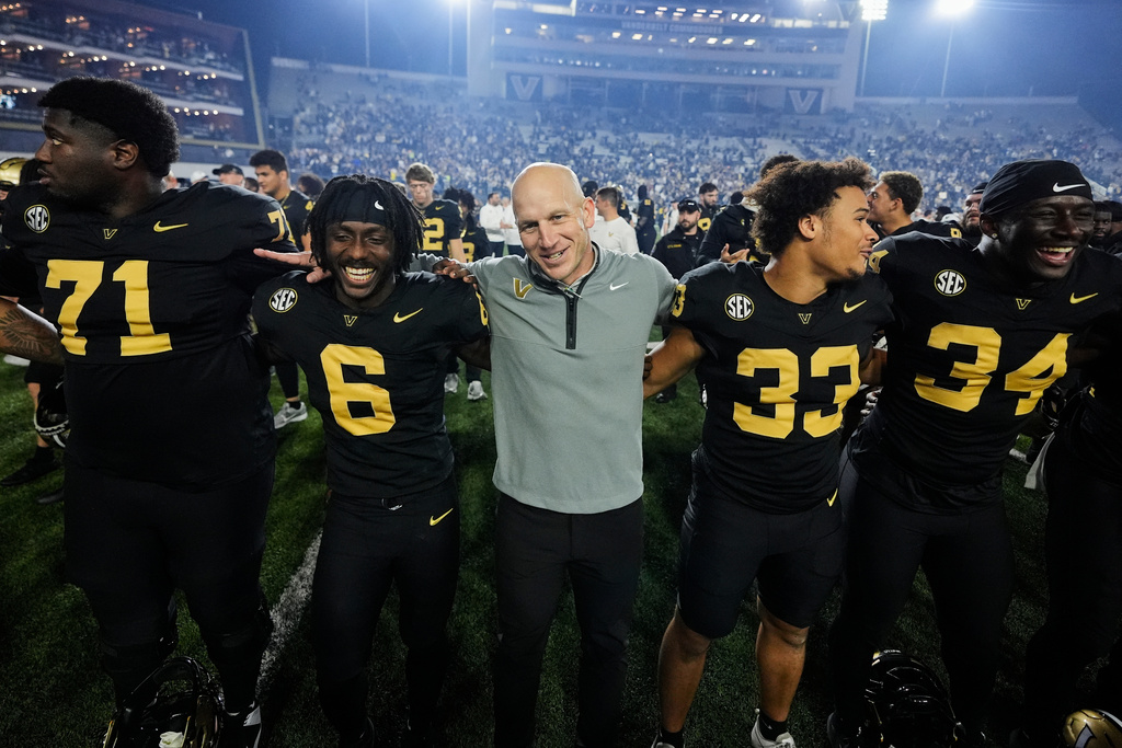 Vanderbilt head coach Clark Lea, center, celebrates the team's win with players after an NCAA college football game against Kentucky, Saturday, Nov. 22, 2025, in Nashville, Tenn. (AP Photo/George Walker IV)