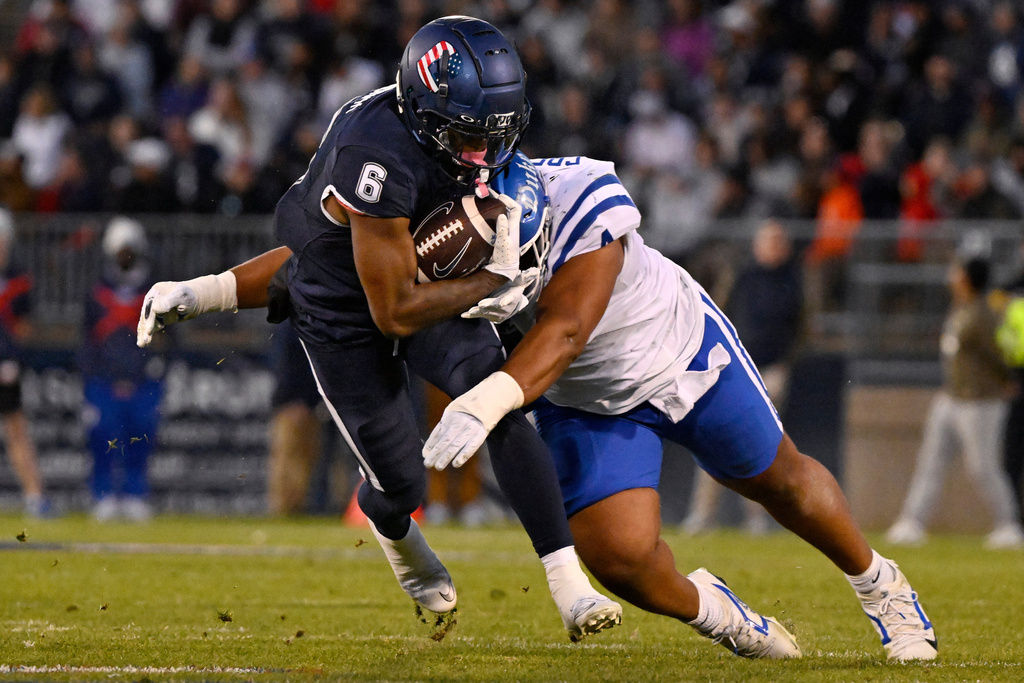 UConn wide receiver Reymello Murphy (6) is tackled by Duke defensive tackle Josiah Green (4) during the first half of an NCAA college football game, Saturday, Nov. 8, 2025, in East Hartford, Conn. (AP Photo/Jessica Hill)
