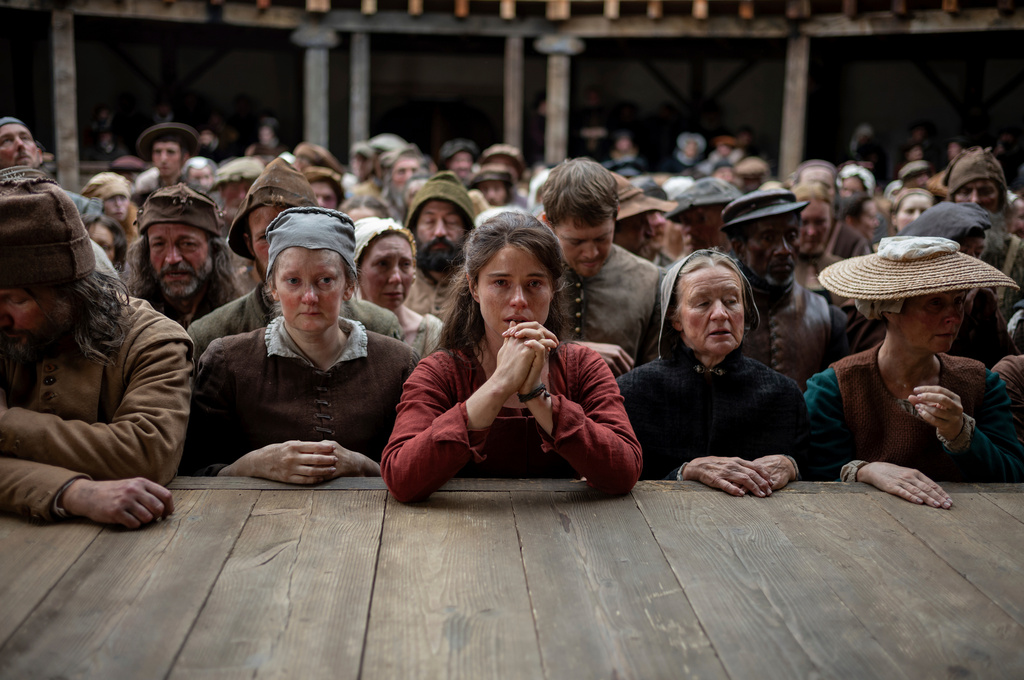 This image released by Focus Features shows Jessie Buckley, center, in a scene from "Hamnet." (Agata Grzybowska/Focus Features via AP)
