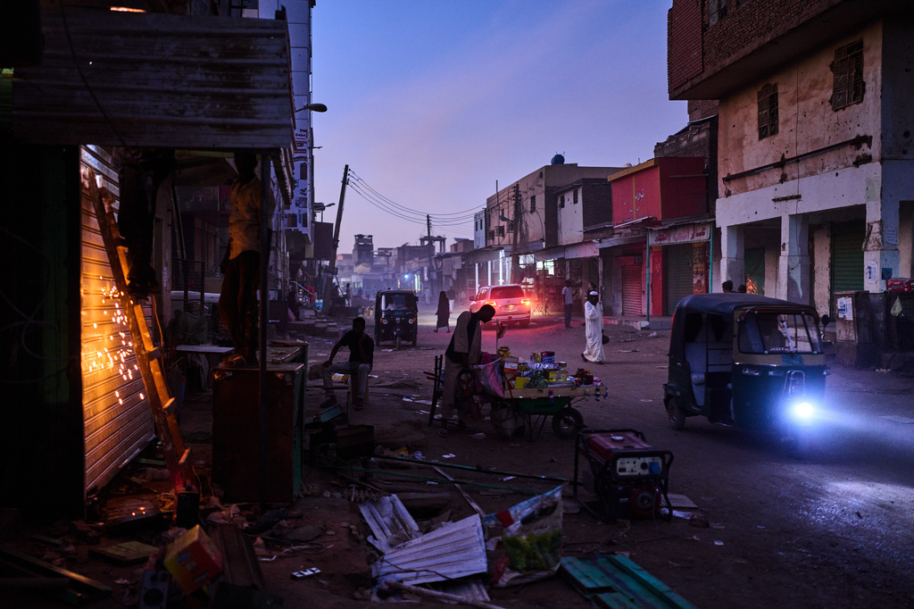 Men work in downtown Omdurman, Sudan, on the outskirts of Khartoum, Friday, April 17, 2026. (AP Photo/Bernat Armangue)