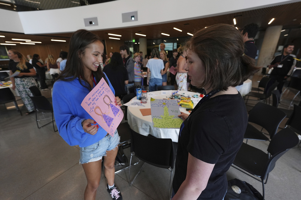 Dasha Zubareva, left, of New York City, confers with Zala Klemenc of Louisville, Colo., at a workshop during The Neurodiversity Alliance summit on the campus of the University of Denver Friday, Aug. 8, 2025, in Denver. (AP Photo/David Zalubowski)