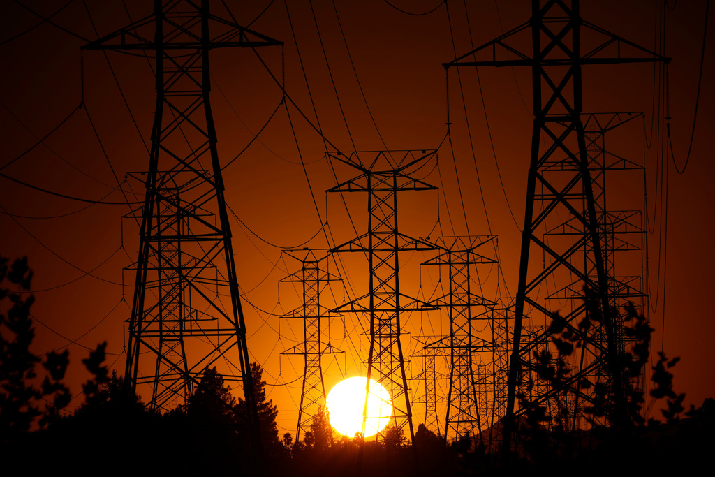 FILE - The sun sets behind high tension power lines, Monday, Sept. 23, 2024, in the Porter Ranch section of Los Angeles. (AP Photo/Mark J. Terrill, File)