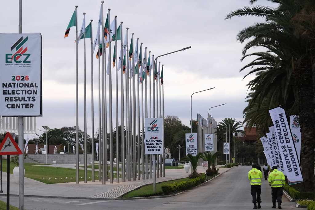 Zambian army officers walk outside the precinct of the election results center at the Mulungushi International Conference Centre in Lusaka, Zambia, Friday, Aug. 14, 2026. (AP Photo/Anita Reed)