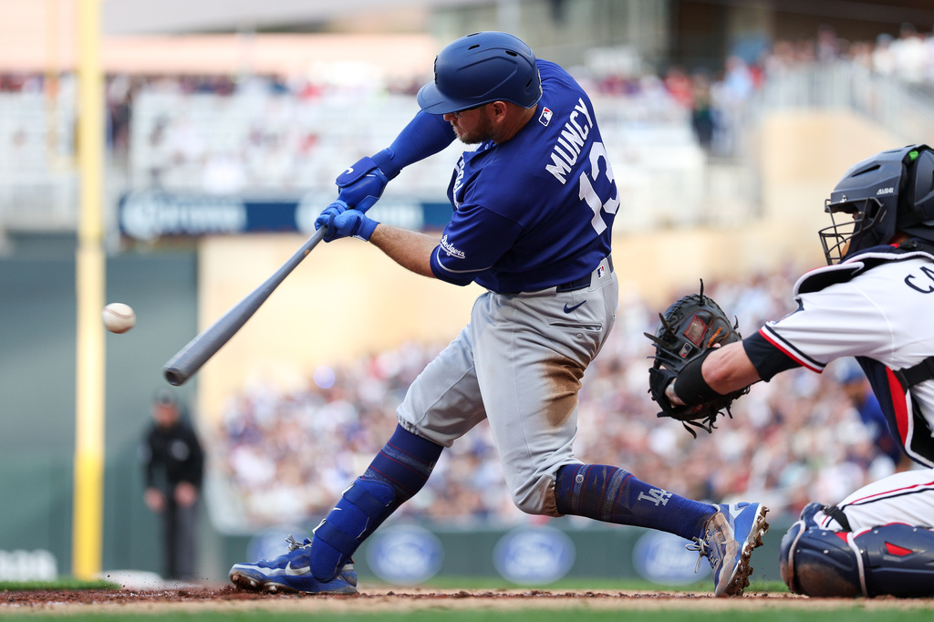 Los Angeles Dodgers' Max Muncy hits an RBI single against the Minnesota Twins during the third inning of a baseball game, Wednesday, June 24, 2026, in Minneapolis. (AP Photo/Matt Krohn)